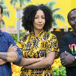 Man with moustache, woman with black hair, Black man all look out with arms crossed